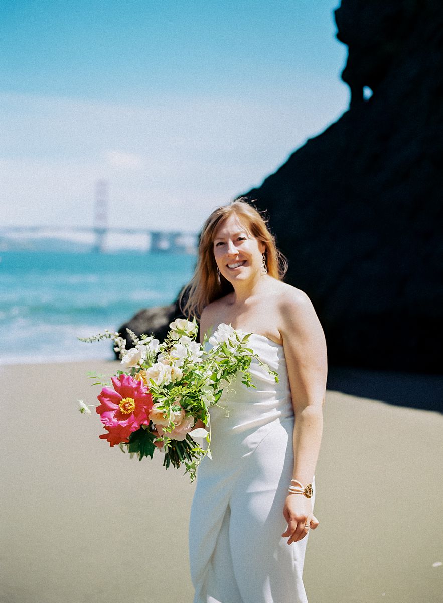 bride holding her bouquet on the beach
