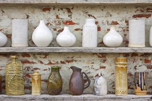 ceramic vintage vases on wooden shelves
