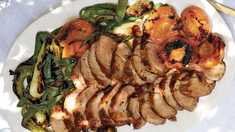 honey-glazed pork tenderloin with grilled apricots served on a white platter