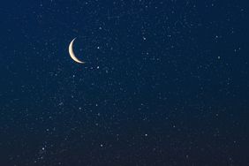 A crescent moon in a starry night sky