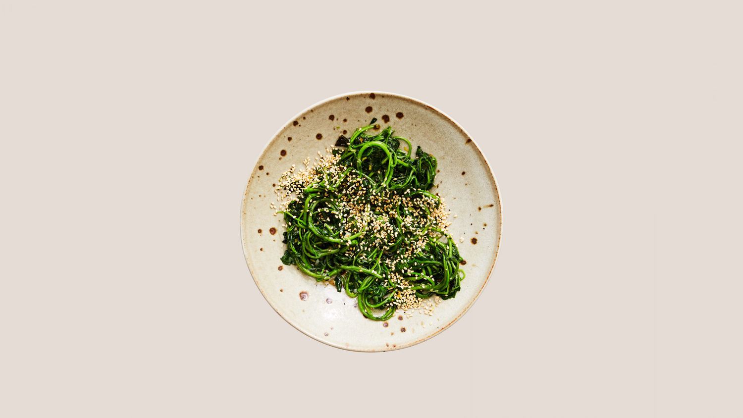 watercress stir-fry topped with sesame seeds