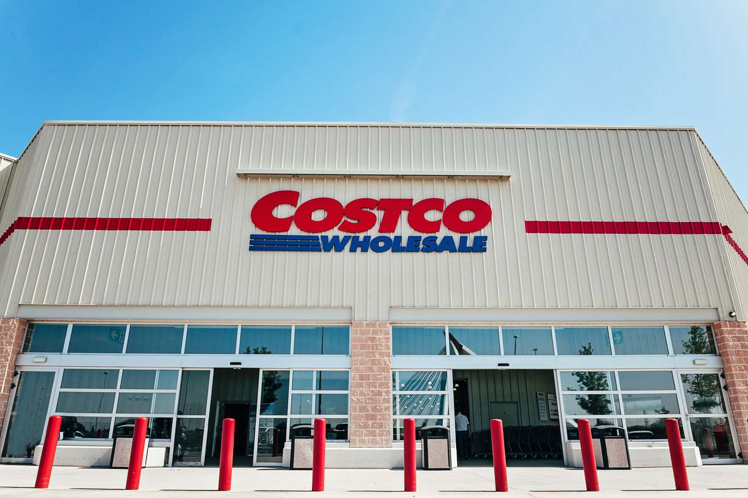 The exterior of a Costco Wholesale store with its logo prominently displayed on the building