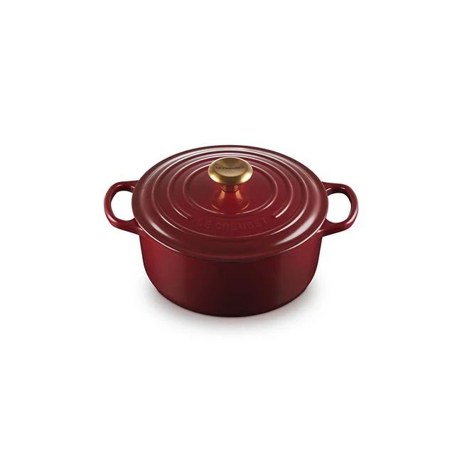 A round cooking pot with handles and a lid featuring a knob on the top