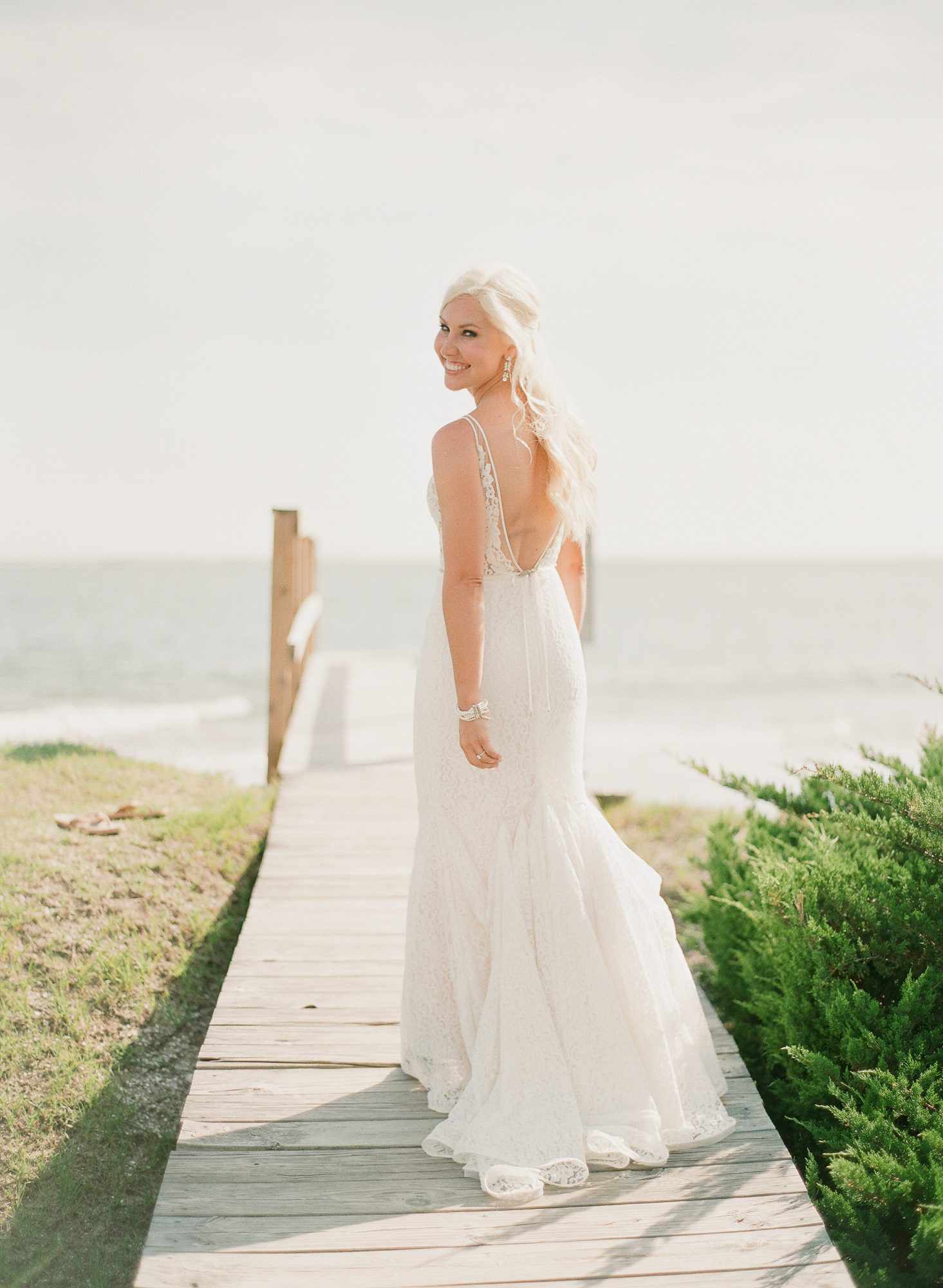 beach wedding dresses bride on boardwalk by the beach