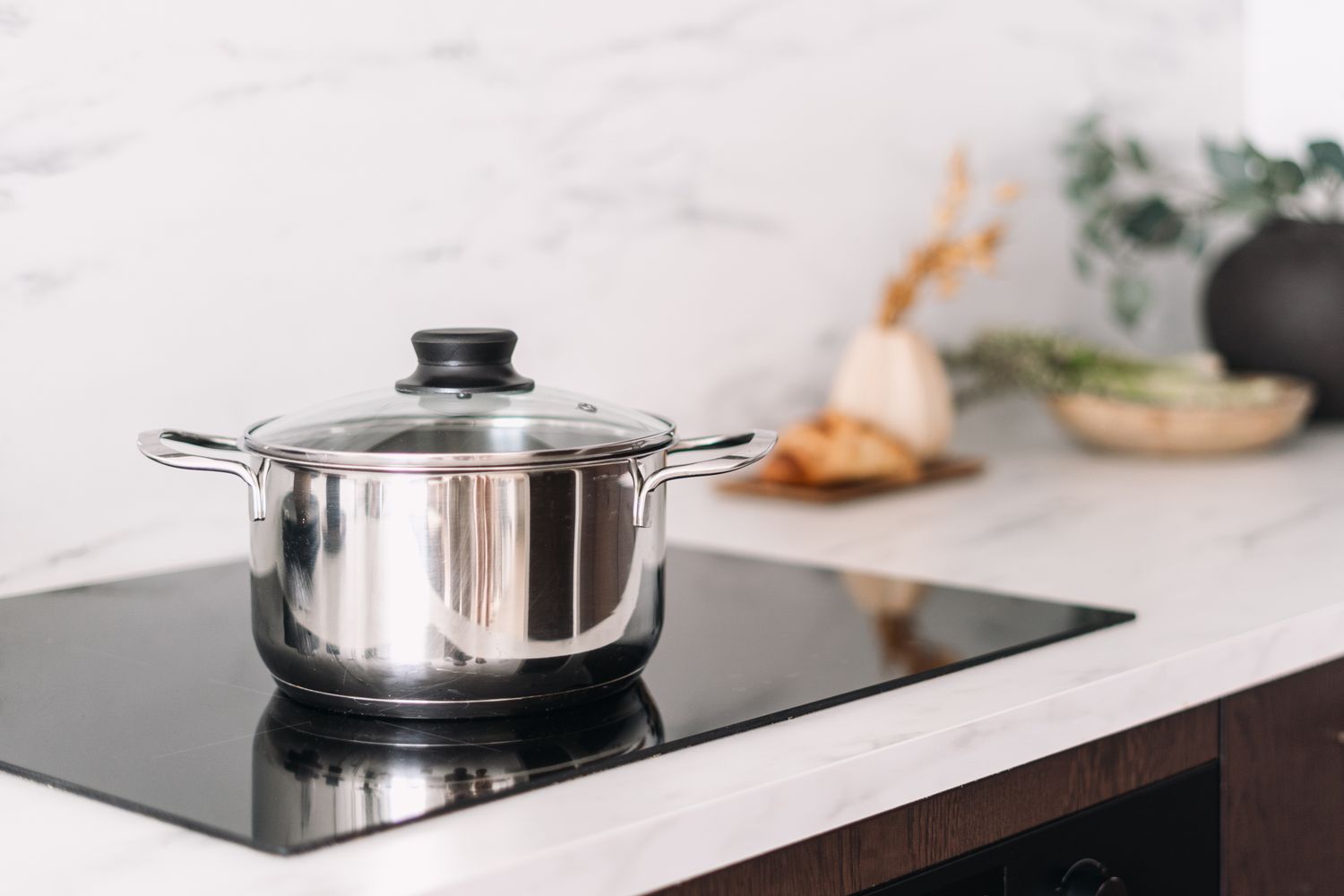 A cooking pot on a modern stovetop in a kitchen setting
