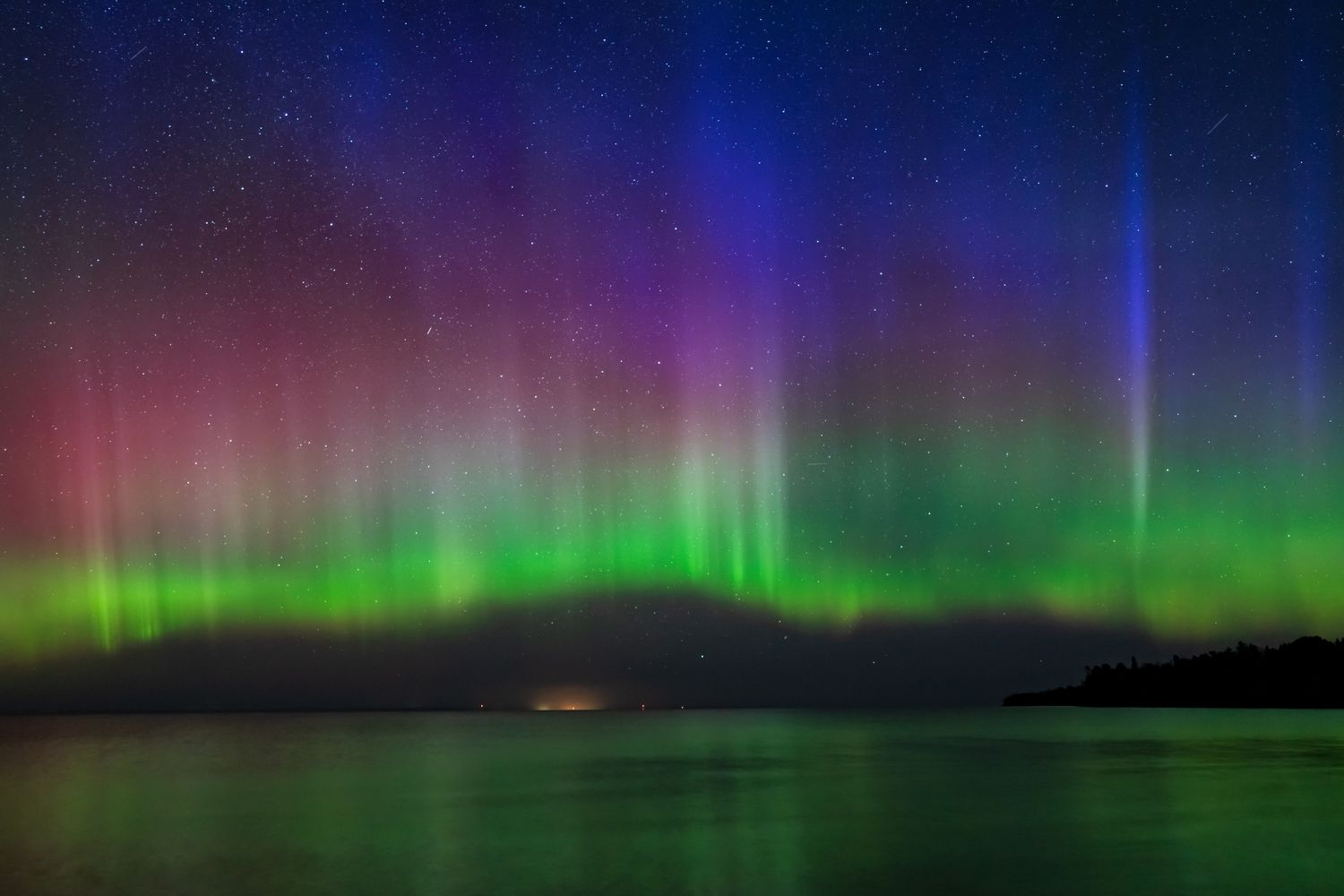 Aurora borealis over a body of water at night