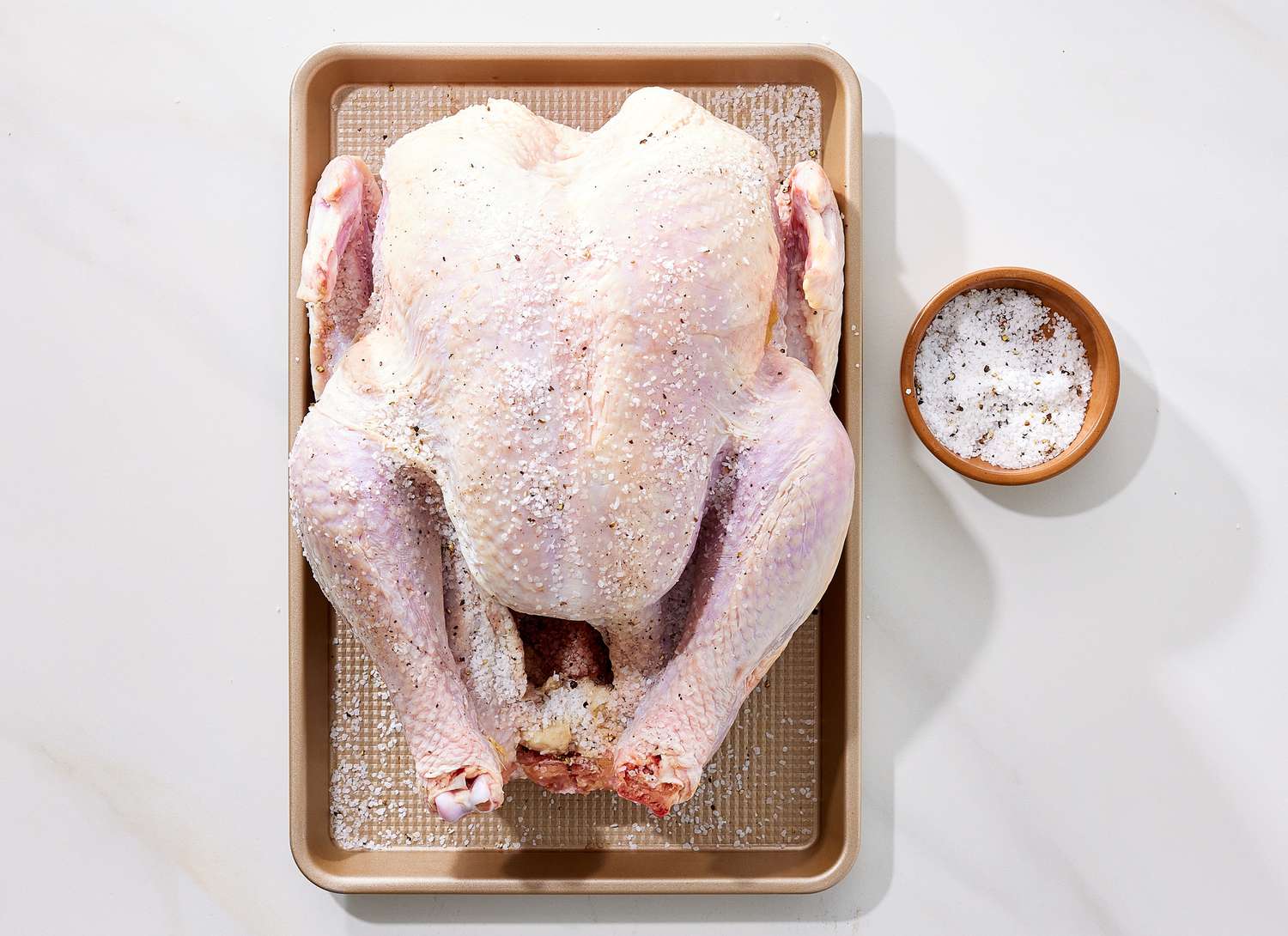 overhead view of raw turkey and salt