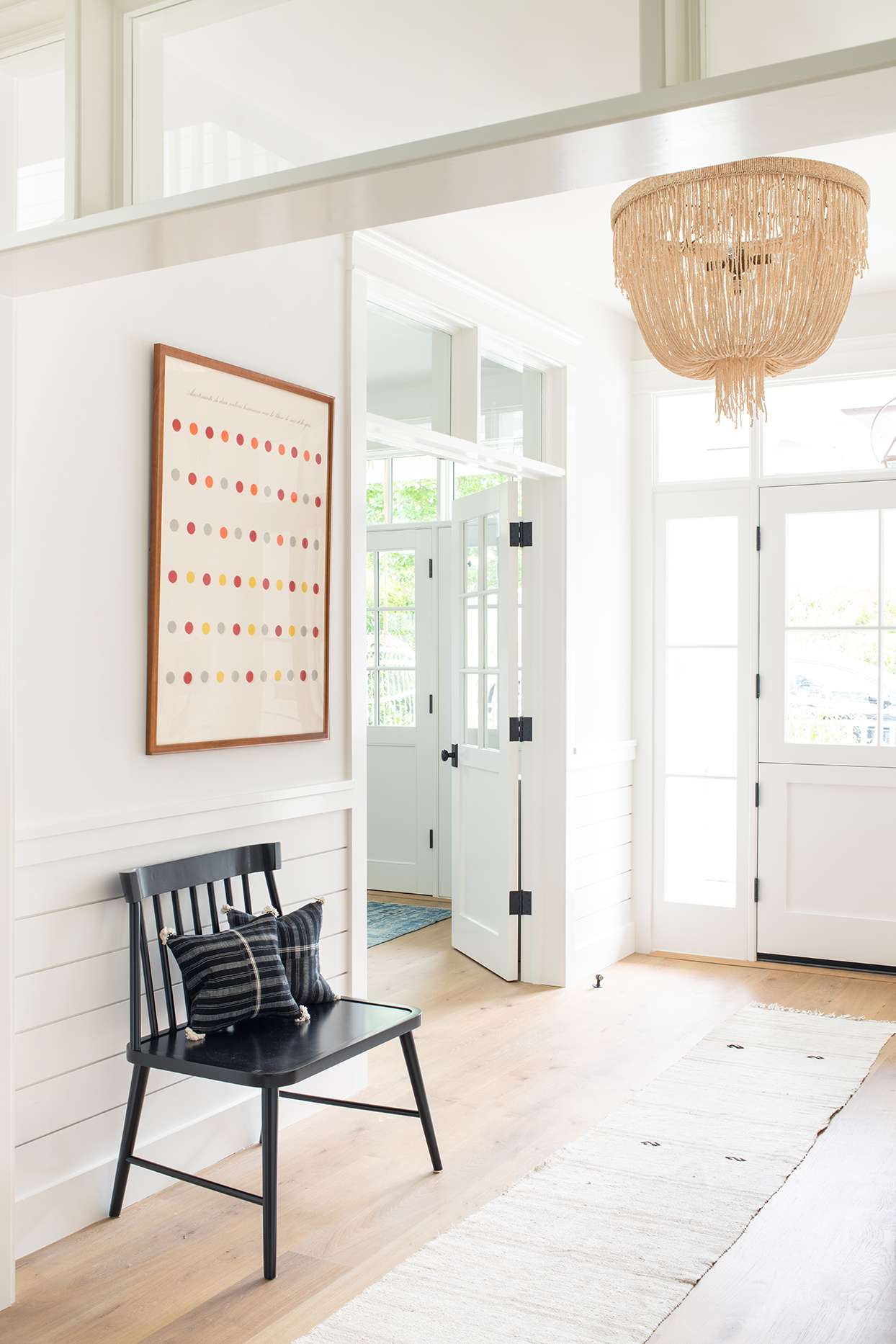 white entryway with lighting accent piece