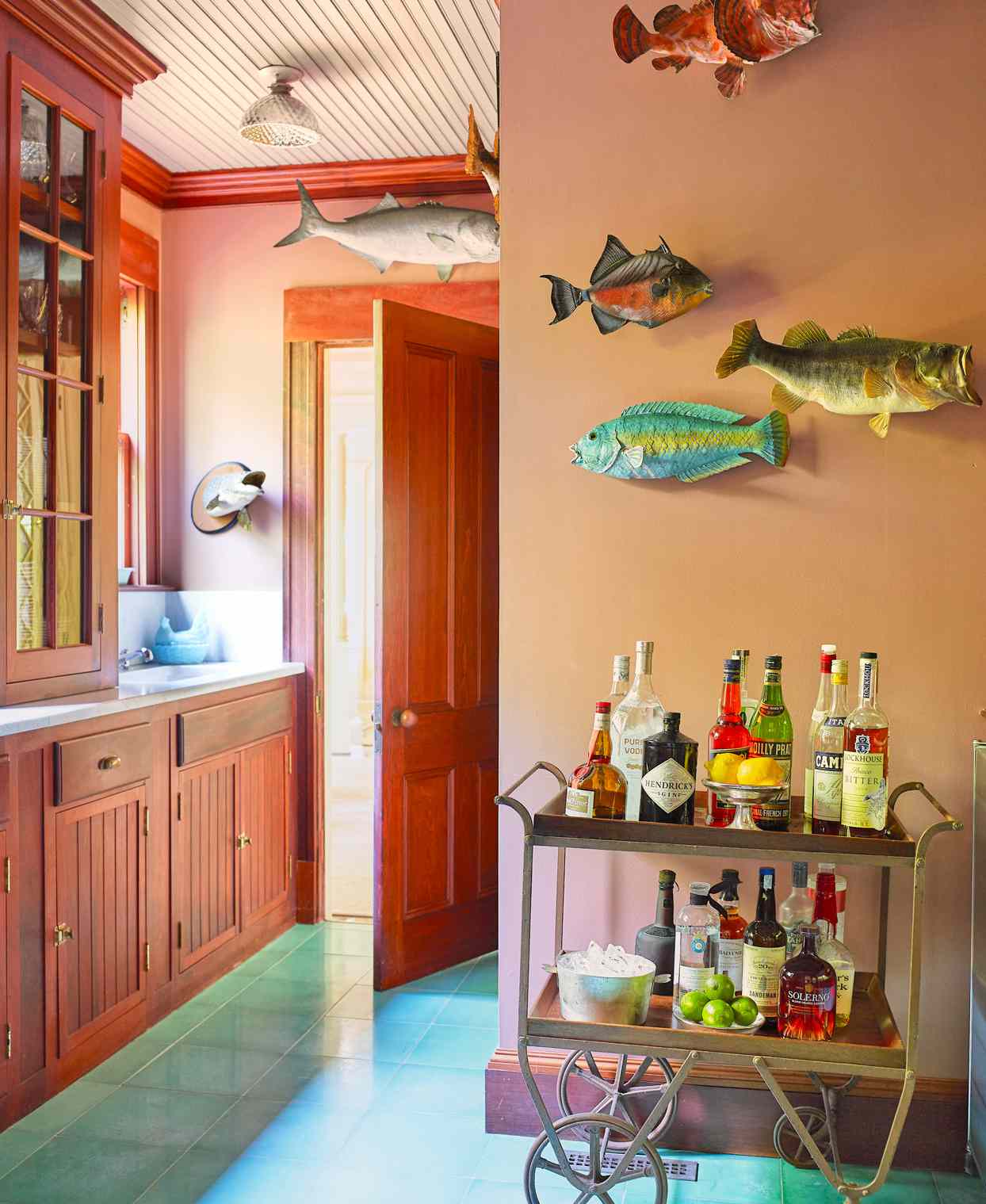 mounted taxidermy fish and antique bar cart