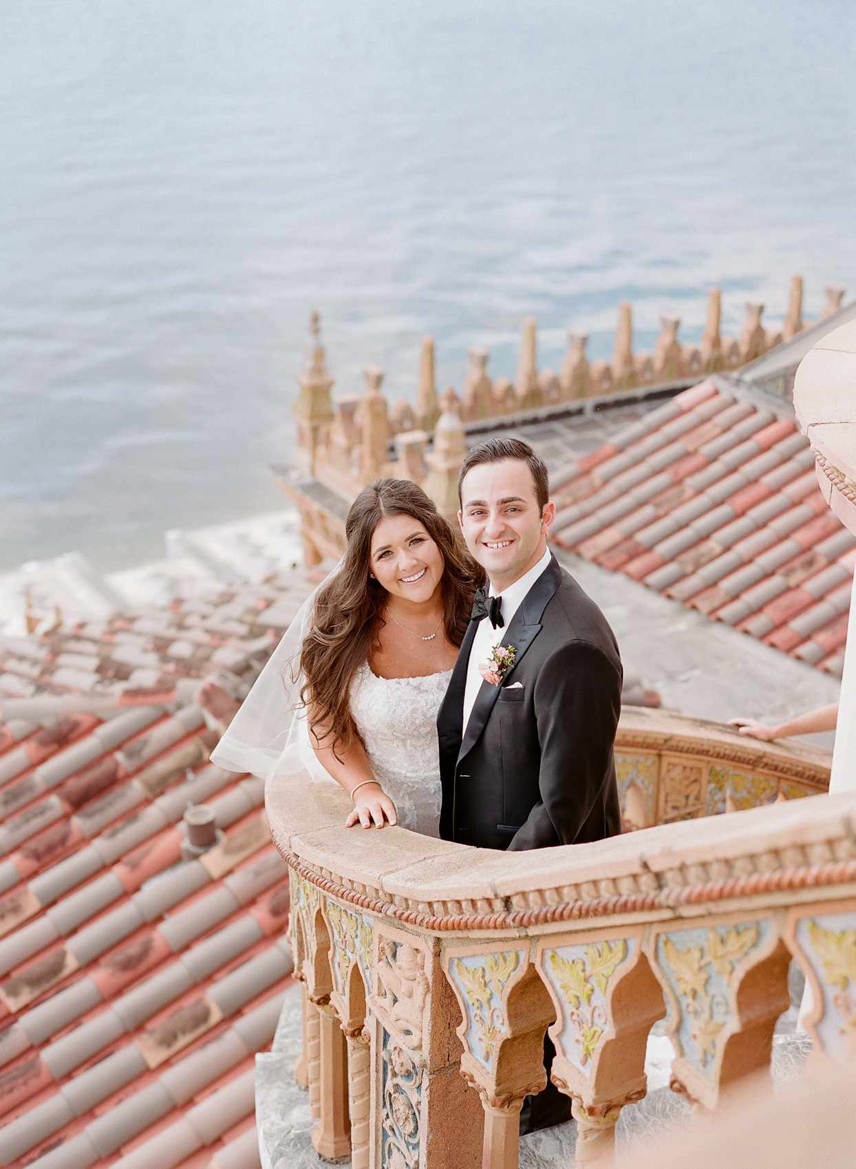 bride and groom smiling on outdoor staircase