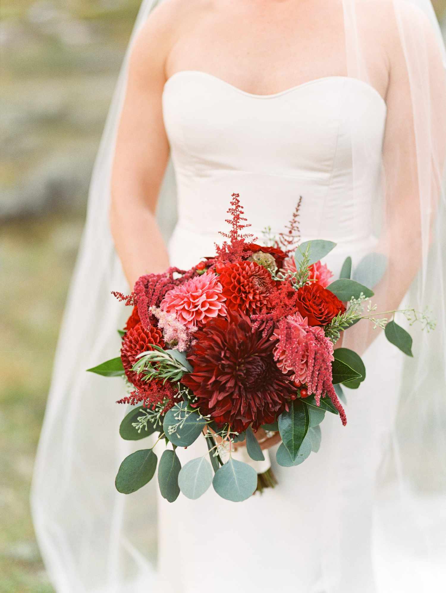 bride holding red bouquet
