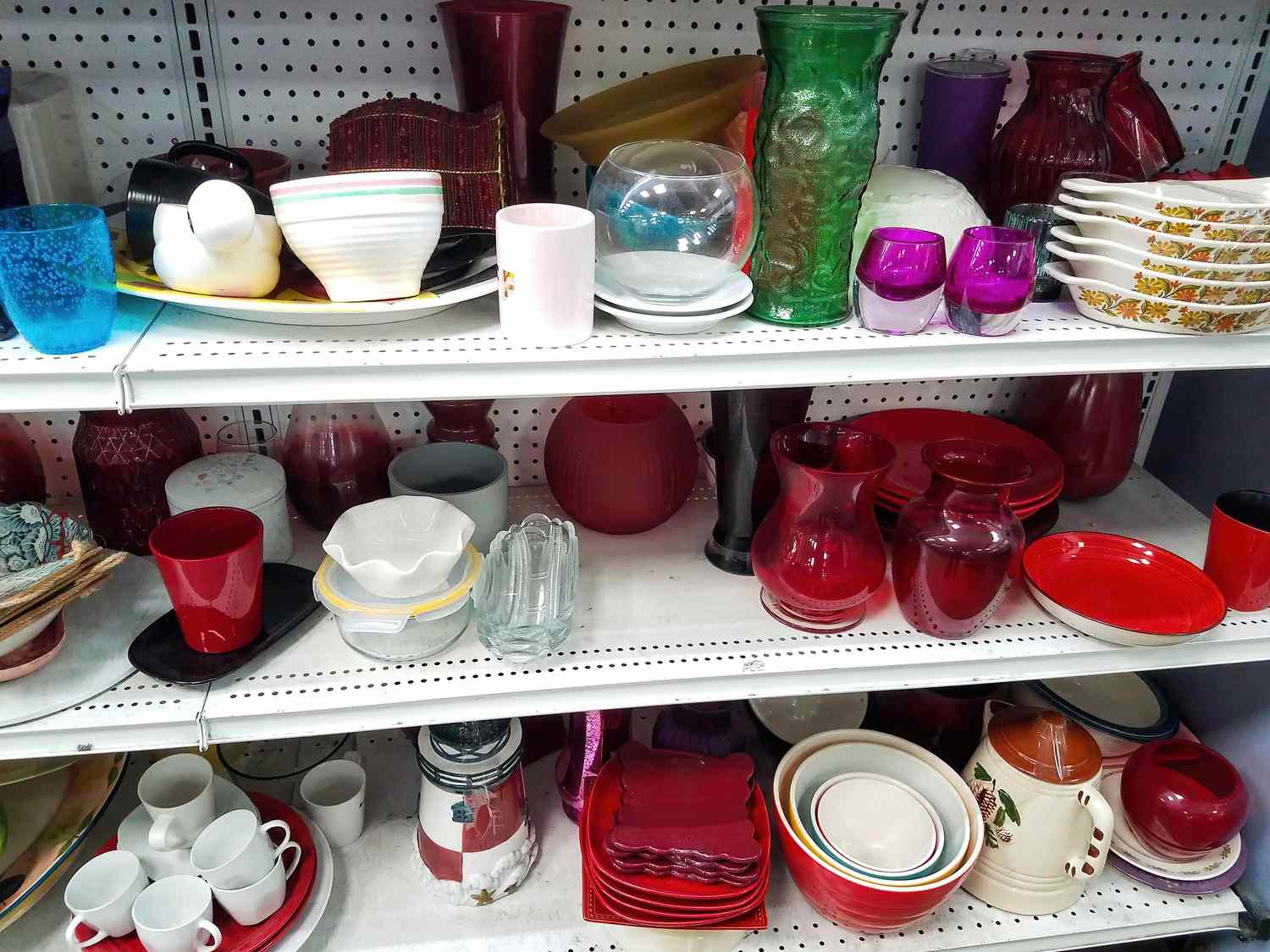 Shelves with a variety of dishes cups and decorative glassware
