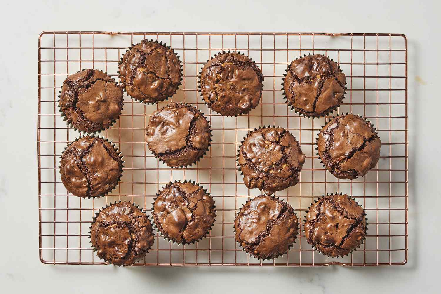 Triple chocolate brownie cups on wire drying rack