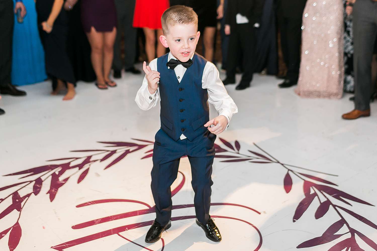 Boy in tux on dance floor at wedding