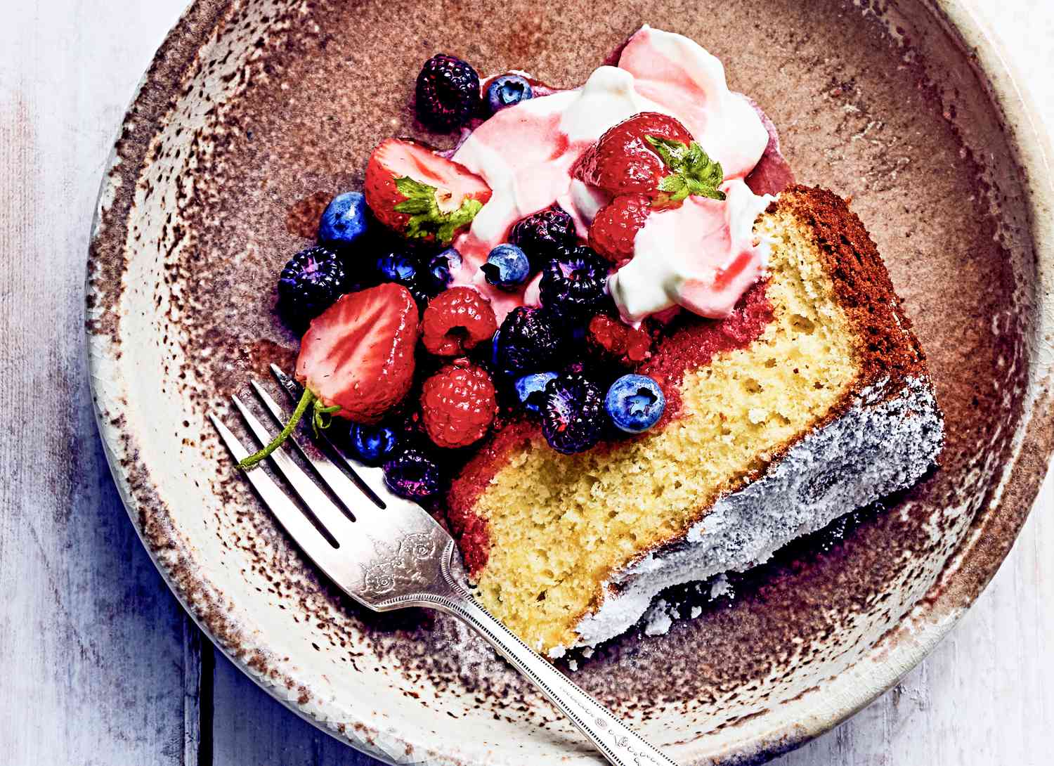 overhead view of lemon olive oil cake with berries
