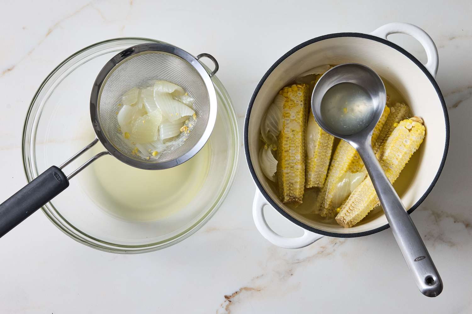 Cooked corn cobs in a pot and a bowl with a strainer containing corn husks