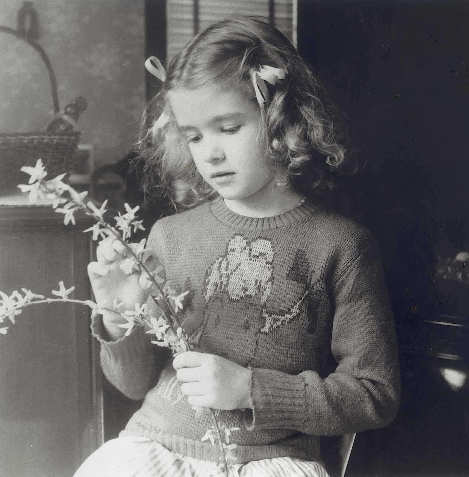 A young Martha arranging handpicked flowers for her mom