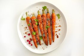 roasted carrots with parsley on white plate