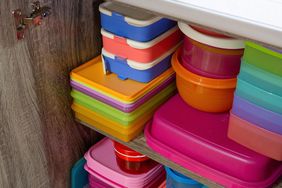 Stacked plastic containers inside a cabinet
