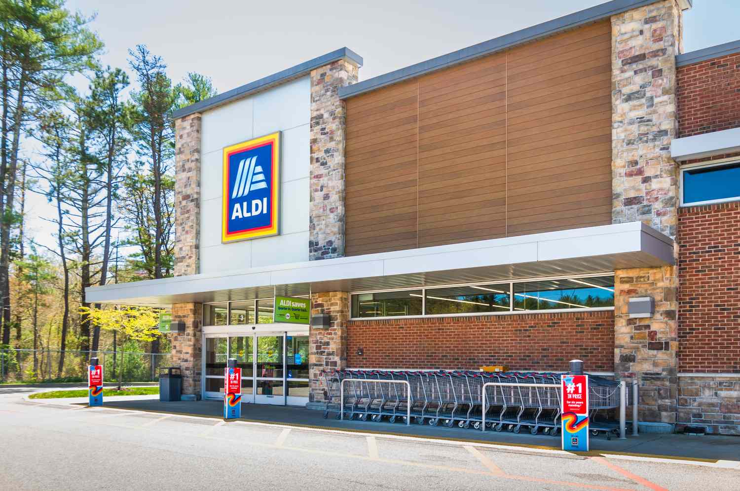 Front entrance of an Aldi grocery store with shopping cart area in front