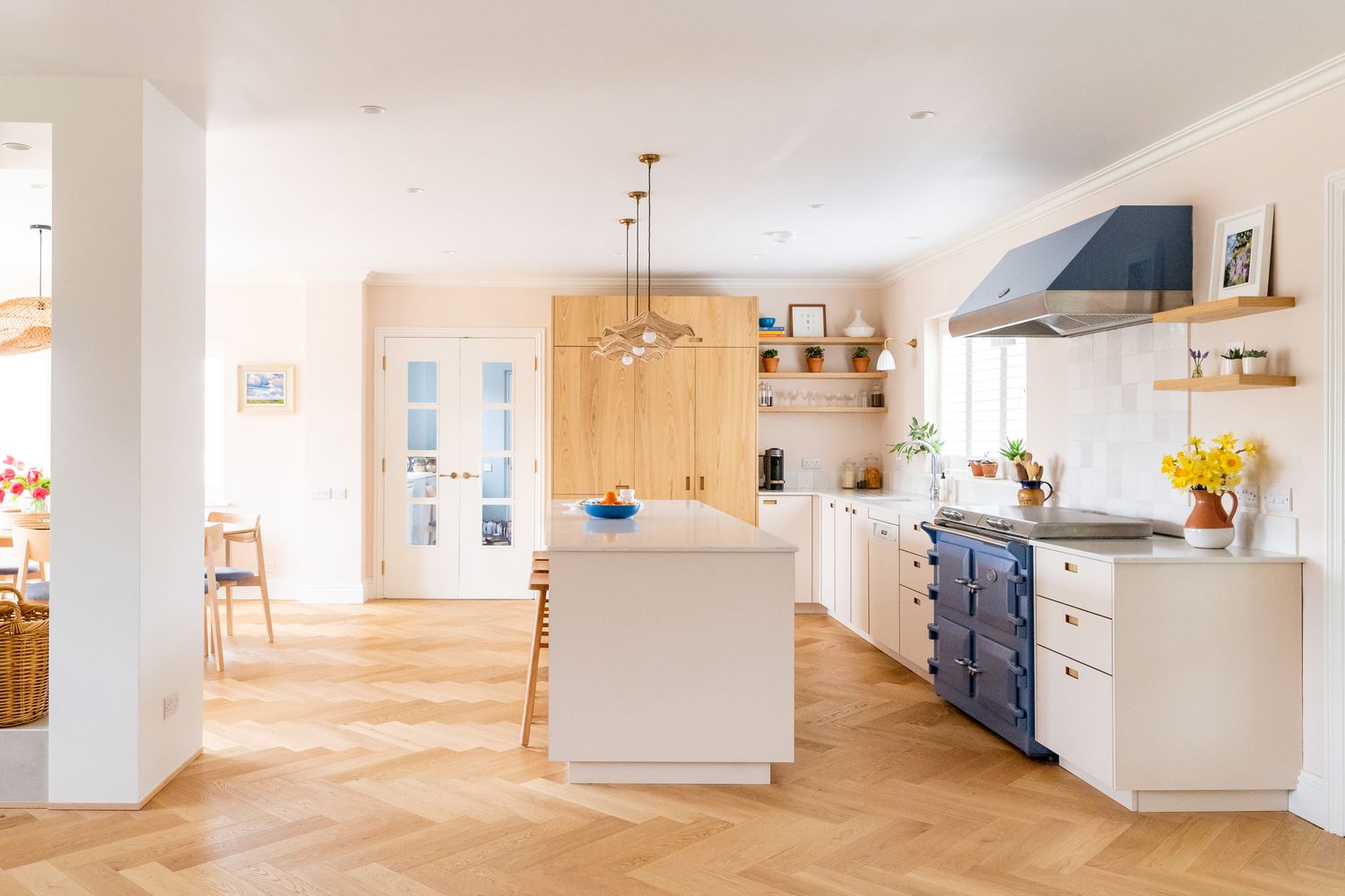 blue range and oven hood in a neutral kitchen