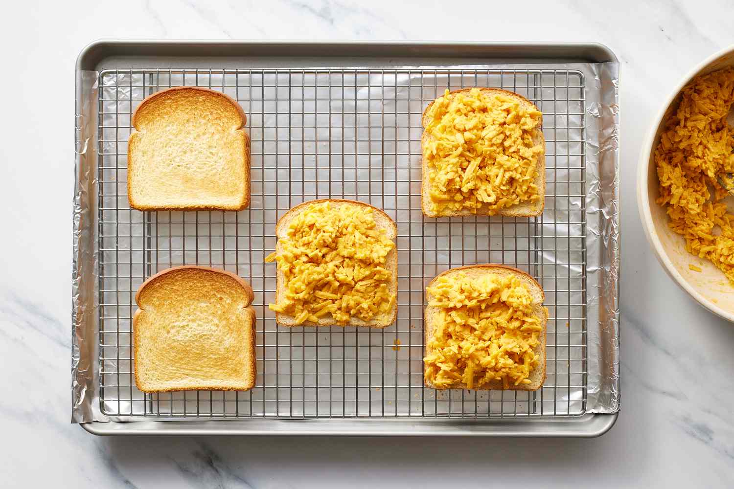 Cheese on bread on baking sheet
