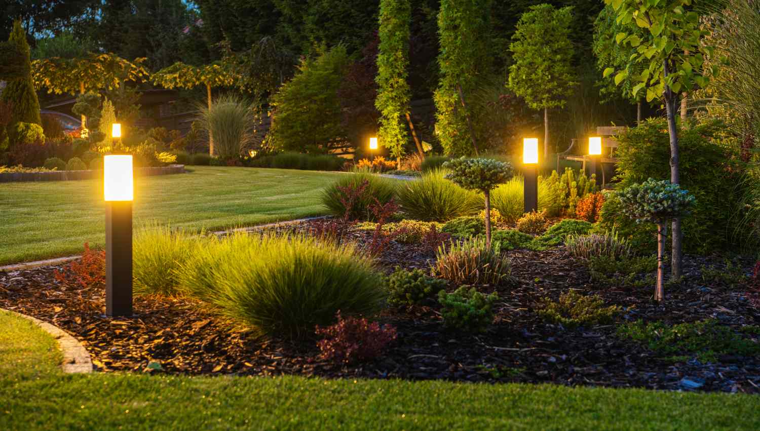 Outdoor garden path with illuminated modern lighting and landscaping features