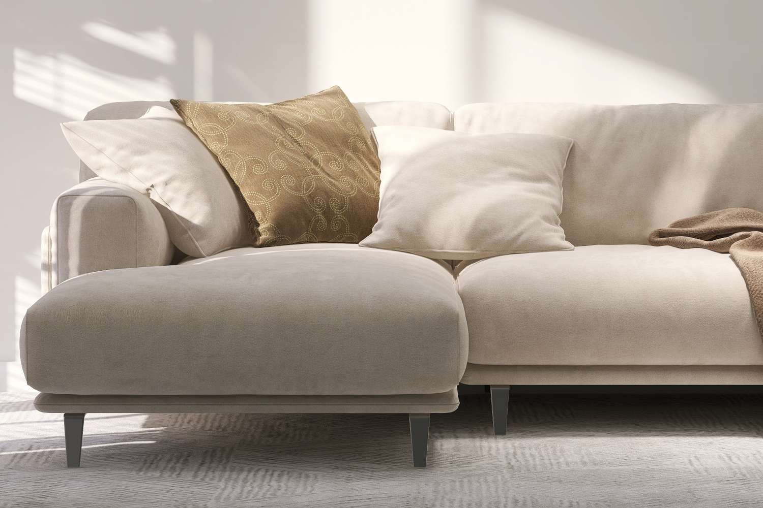 Modern sofa with a chaise lounge and pillows in a living room setting
