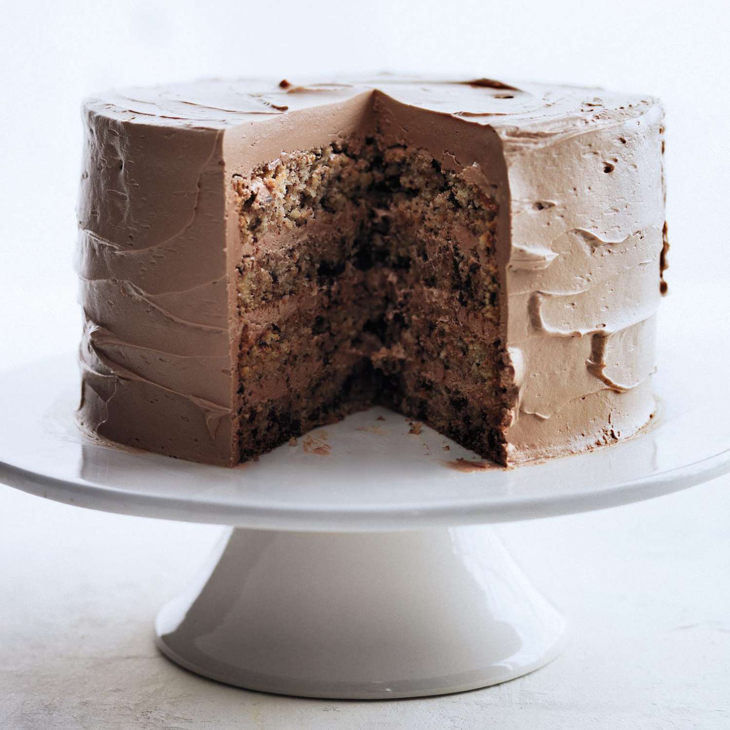 chocolate cake on white cake stand