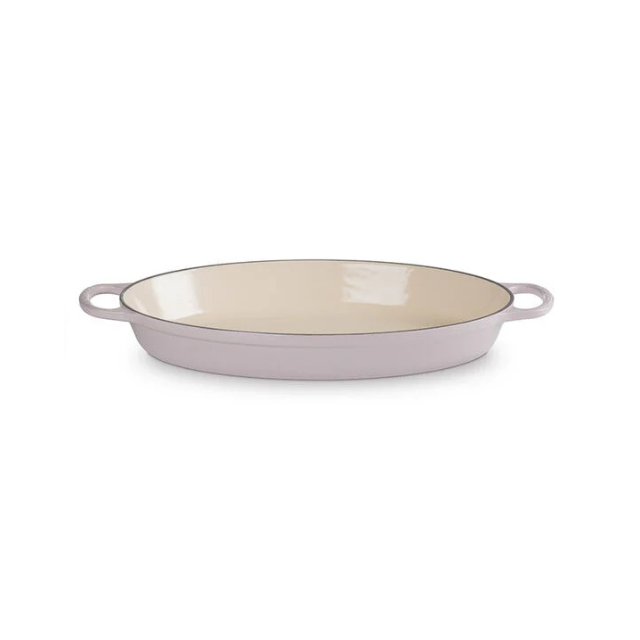 A shallow oval baking dish with handles on both sides