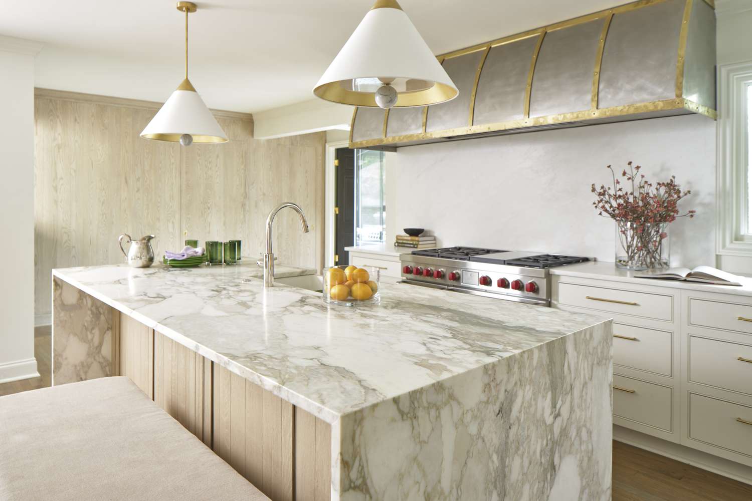 white kitchen with large metal range hood