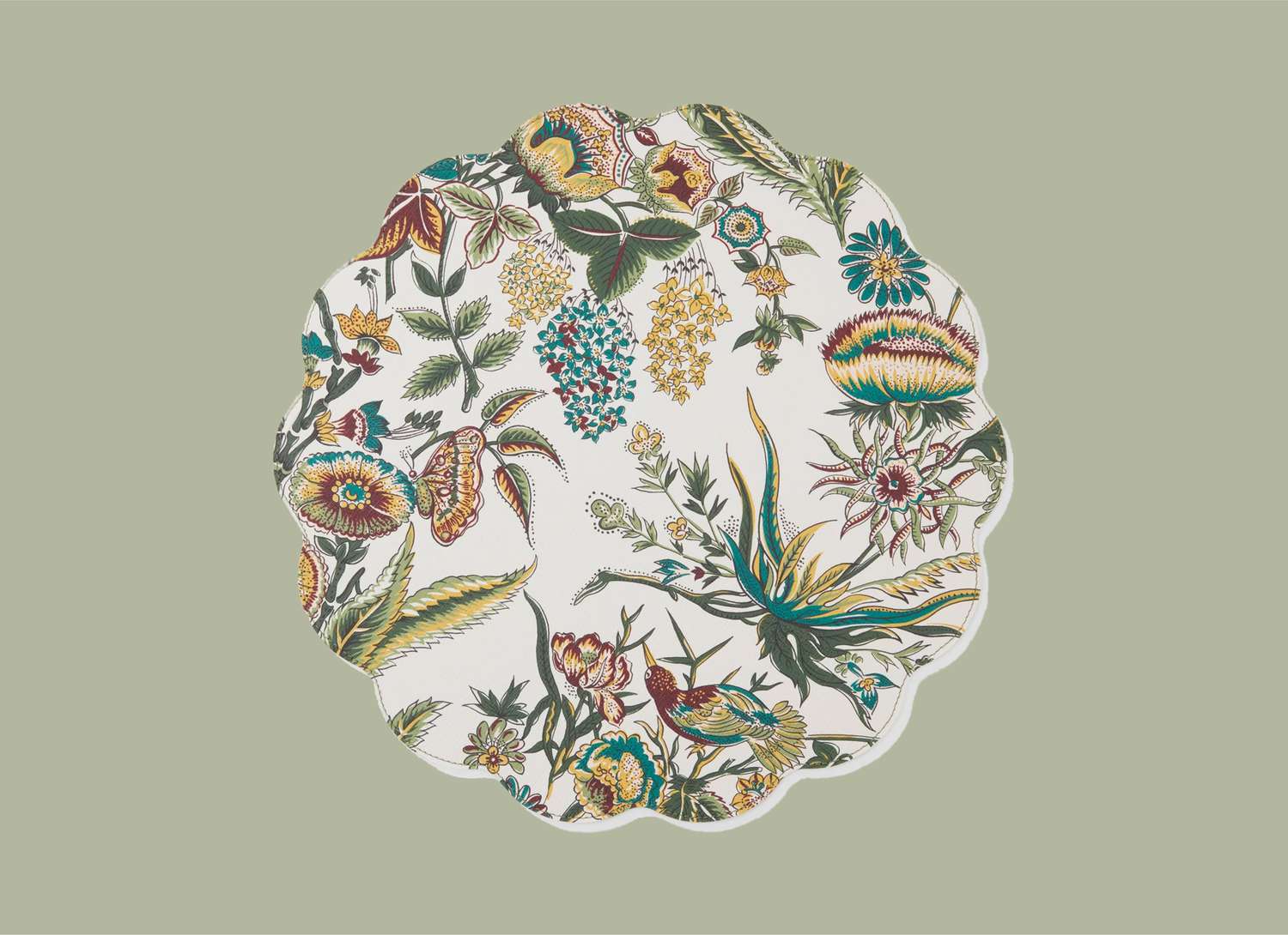 scalloped round patterned placemat on a green background