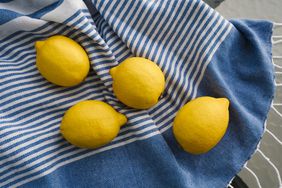 4 lemons on blue and white striped cloth