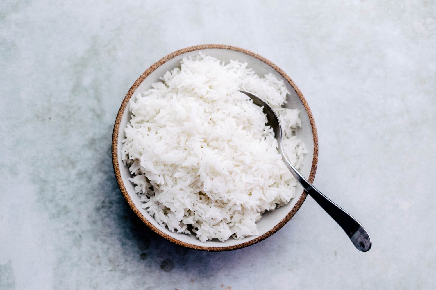 How to Make Perfect White Rice in a Rice Cooker - in bowl with spoon