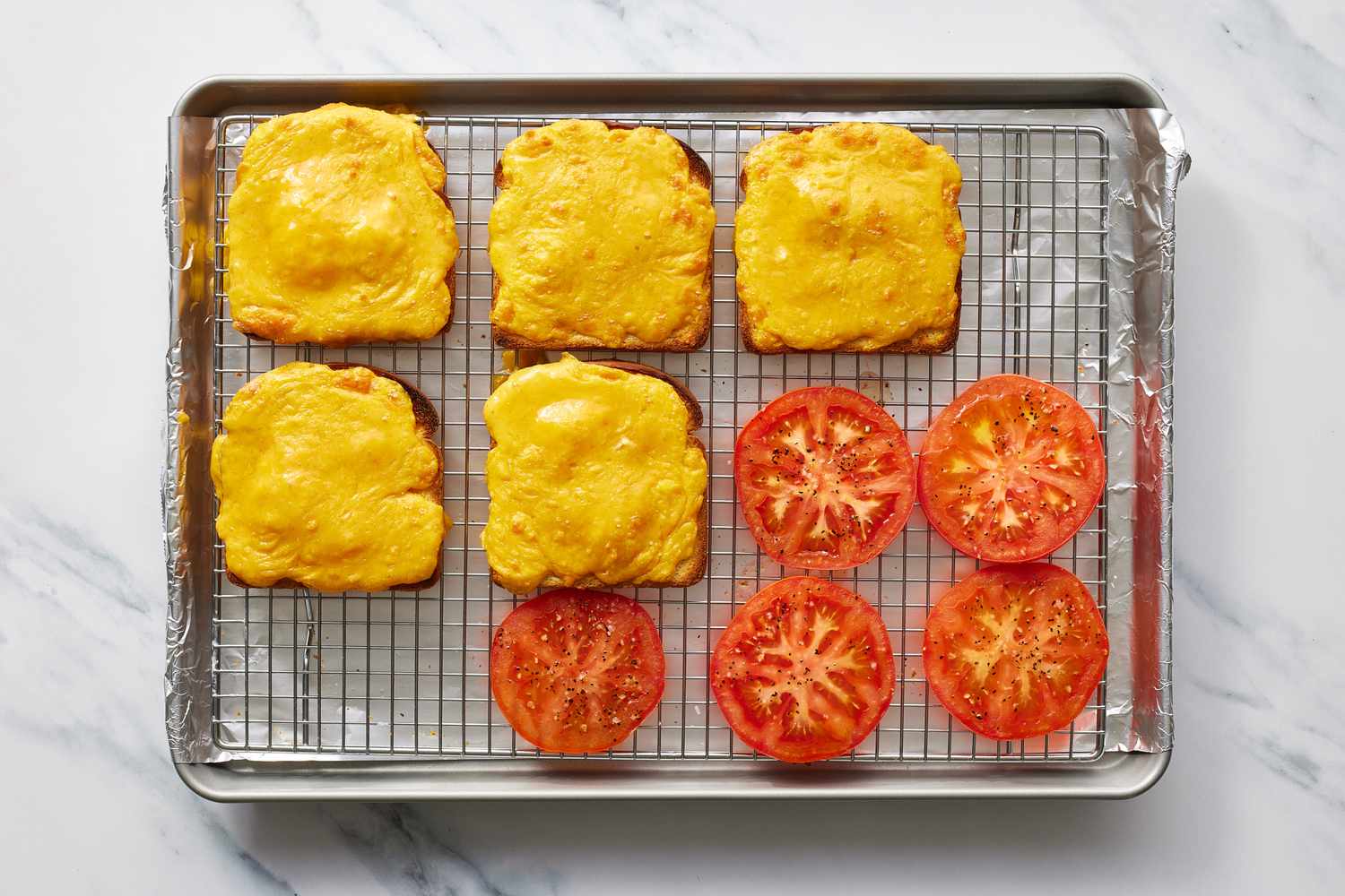 Broiled cheese and tomato in baking sheet for welsh rarebit