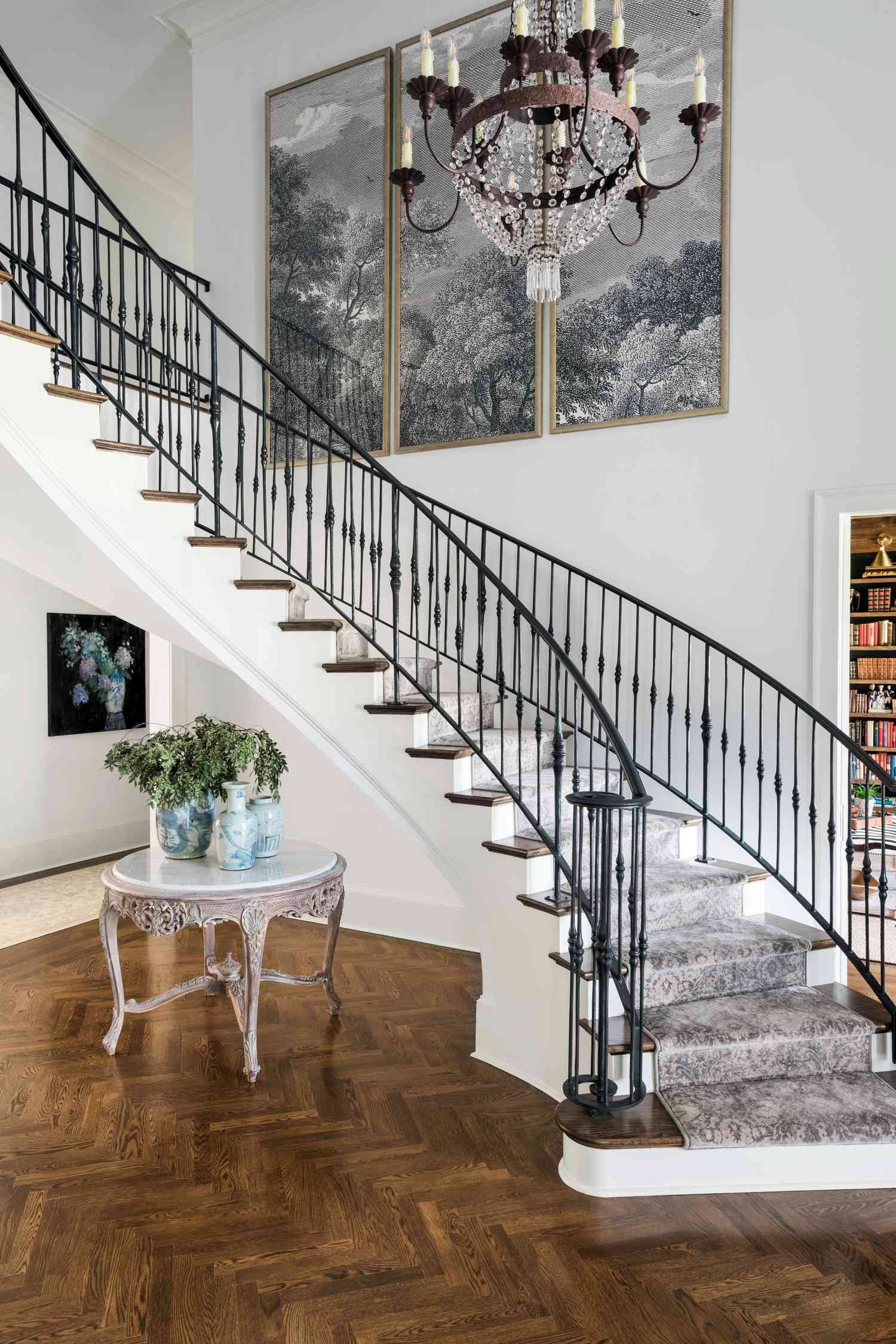 curved iron staircase with stair runner