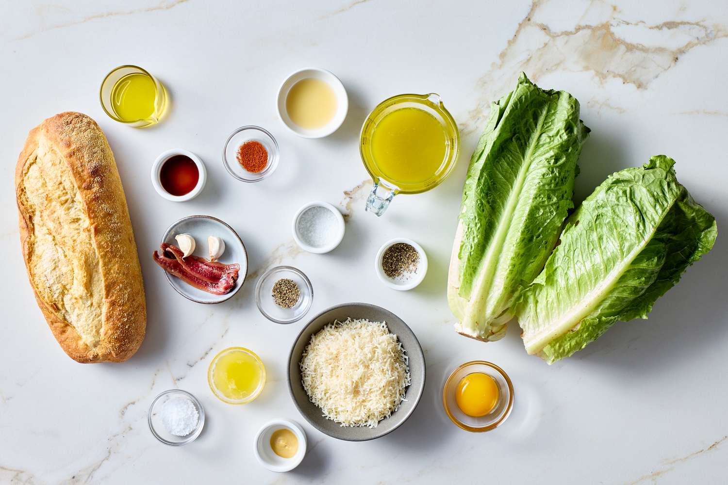 Ingredients laid out for making a Classic Caesar Salad