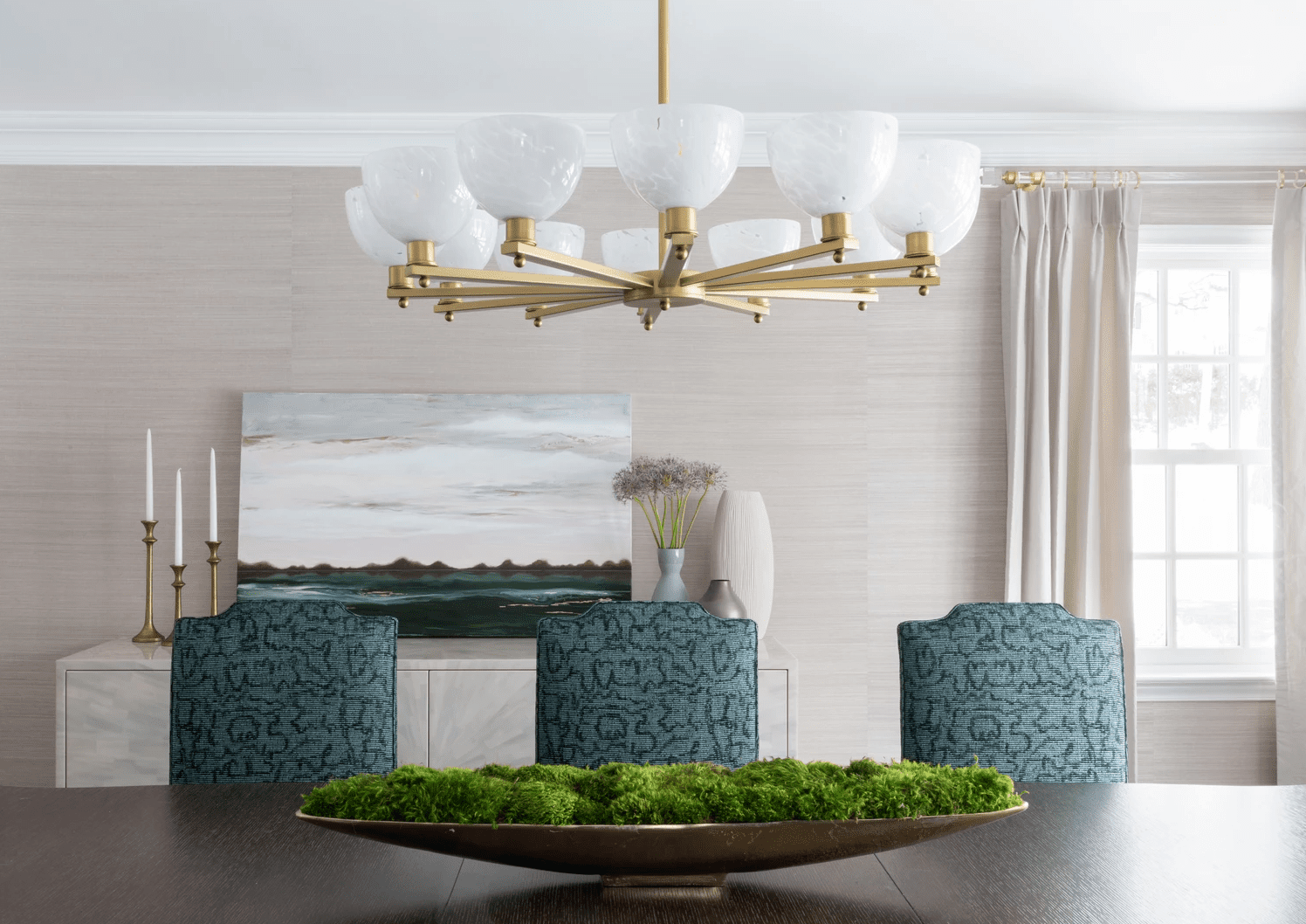 Dining room with large chandelier and taper candles.