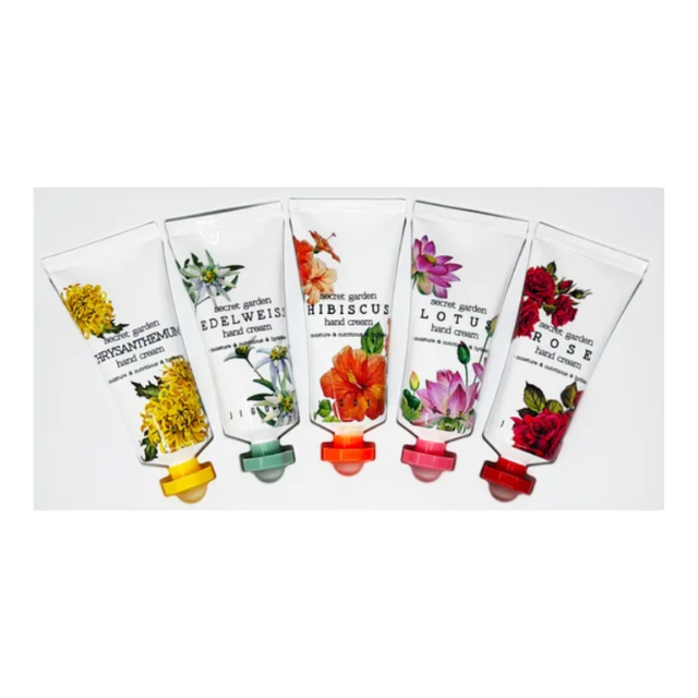 Five tubes of botanical hand cream in a row each labeled with a different flower type
