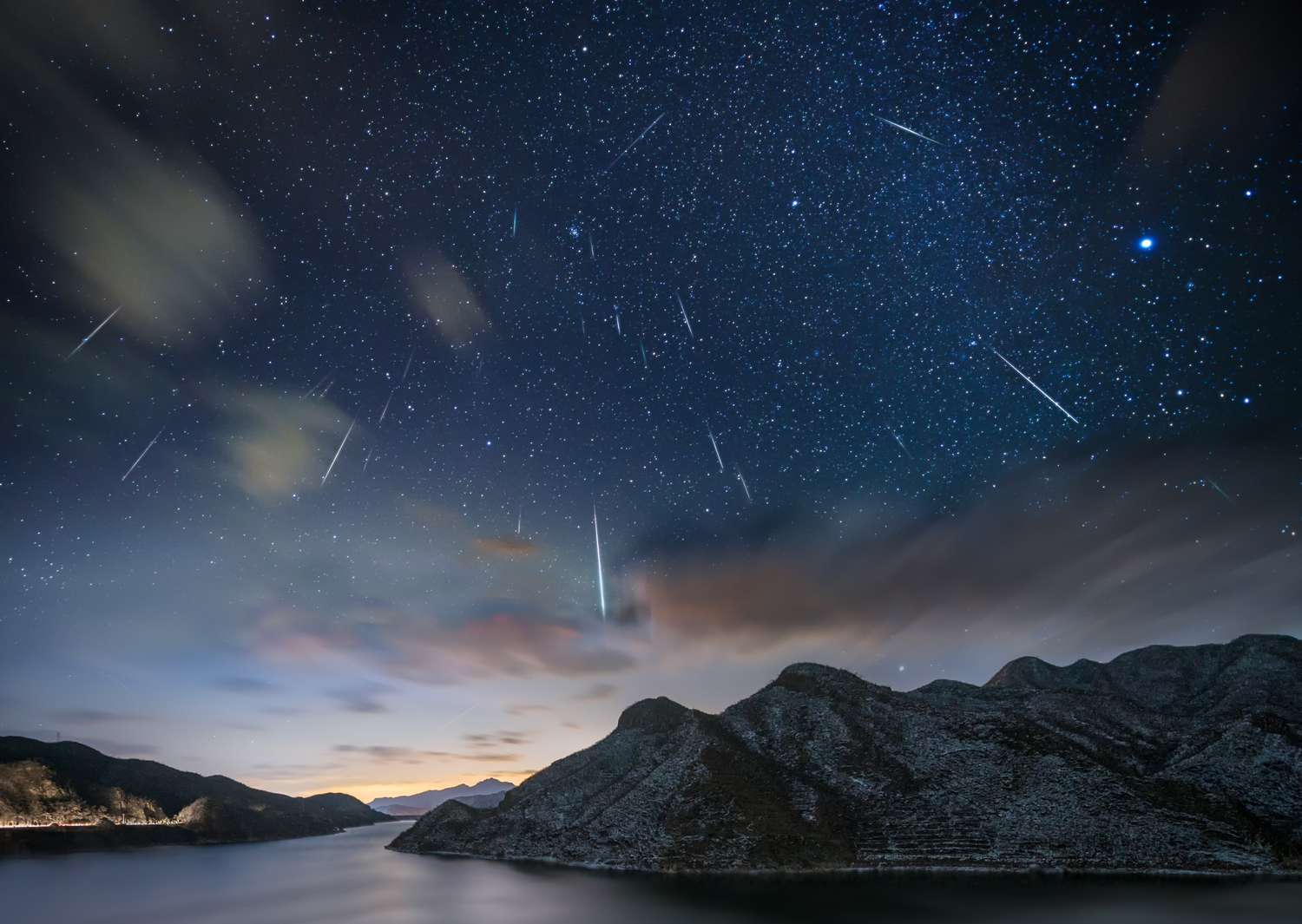Meteor shower over mountains and water