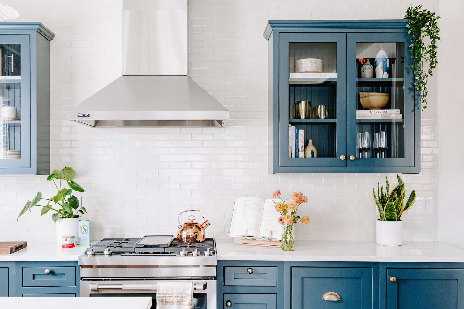 white kitchen with blue cabinets and white tile