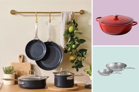 Cookware displayed on a kitchen counter hanging pans and decorative fruit with images of a red pot and silver pans on the side