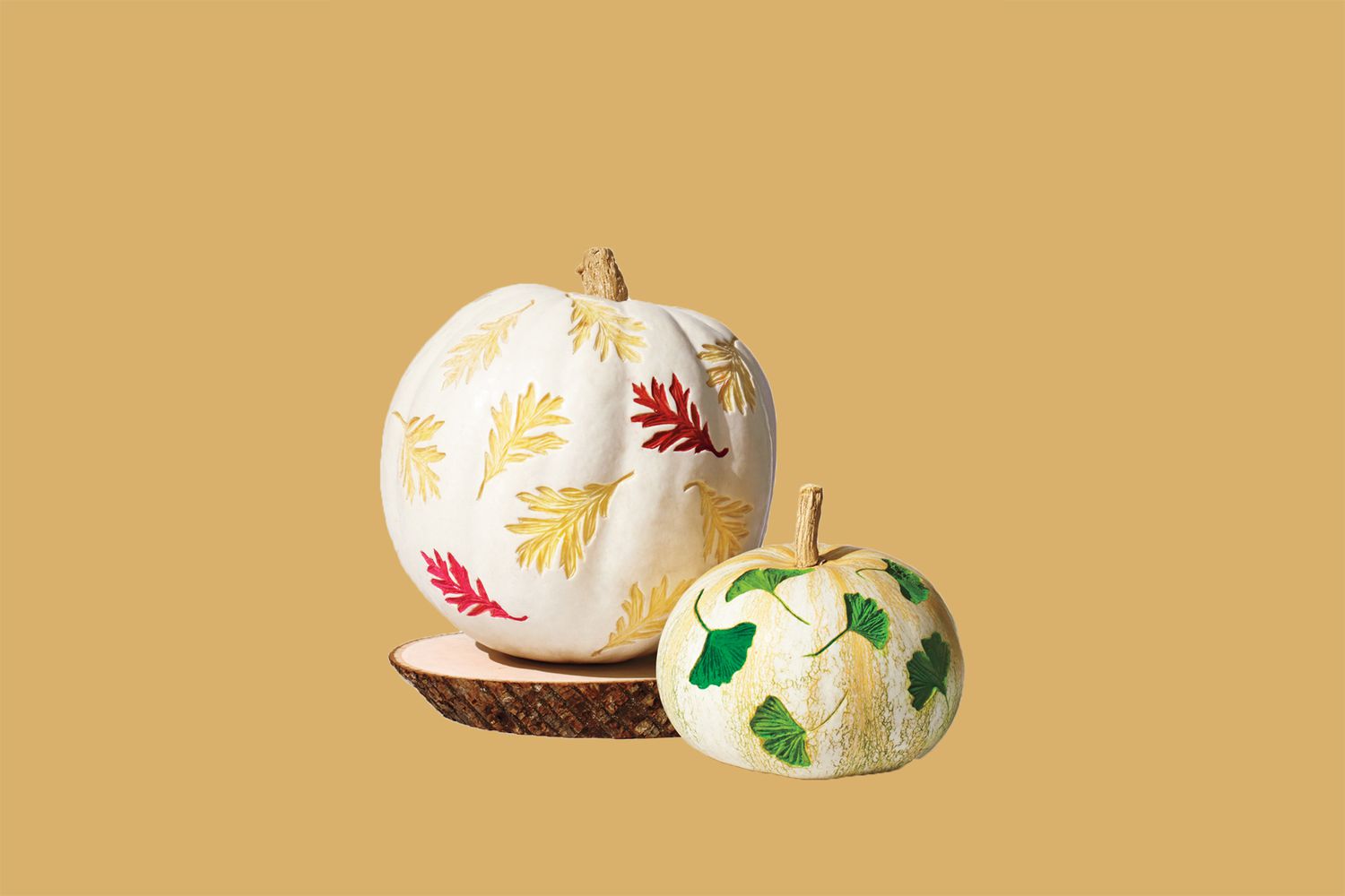 white pumpkins etched with leaves