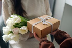 tulips and gift box handed to hostess