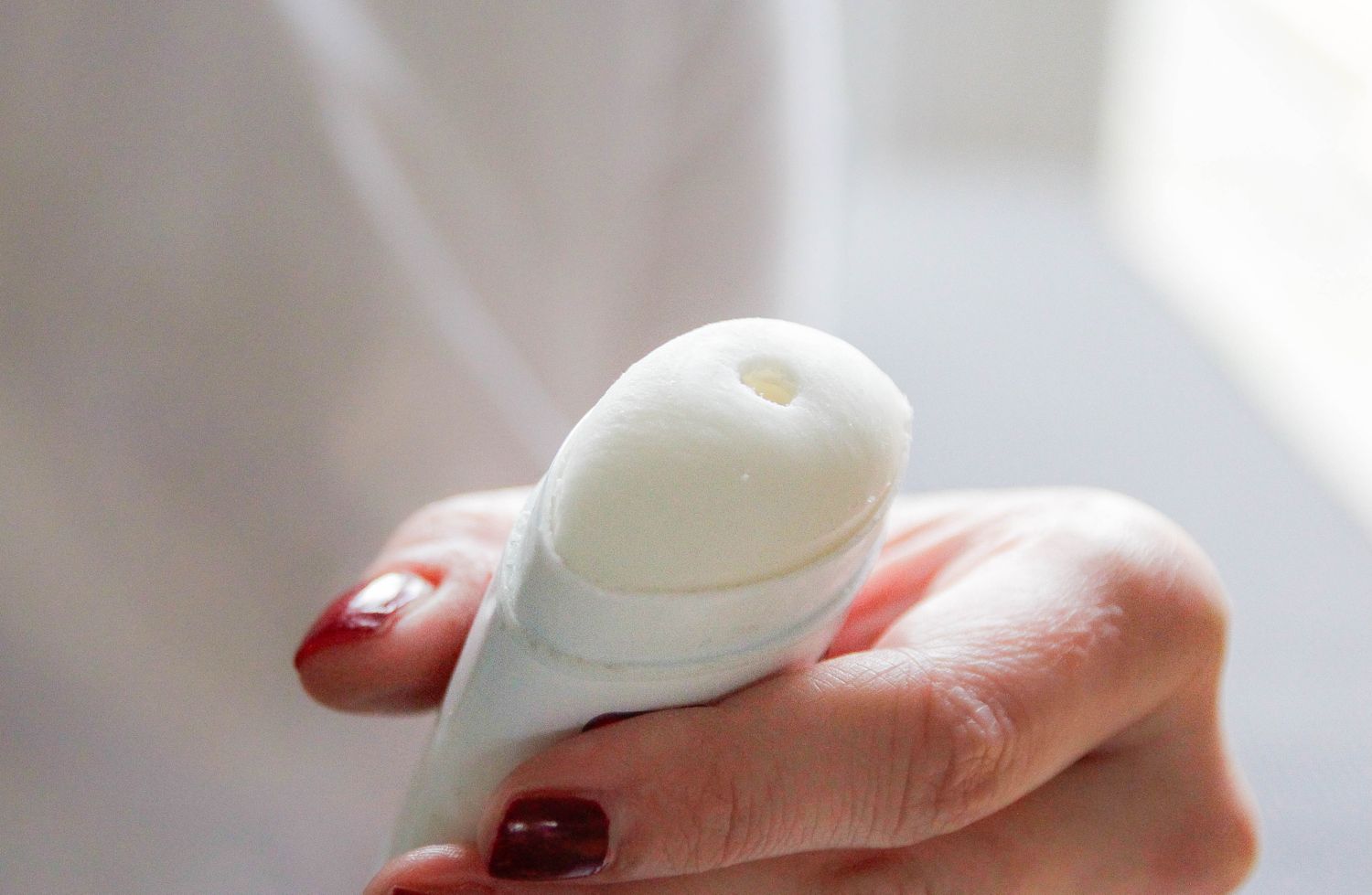 Closeup of a hand holding a deodorant stick opened