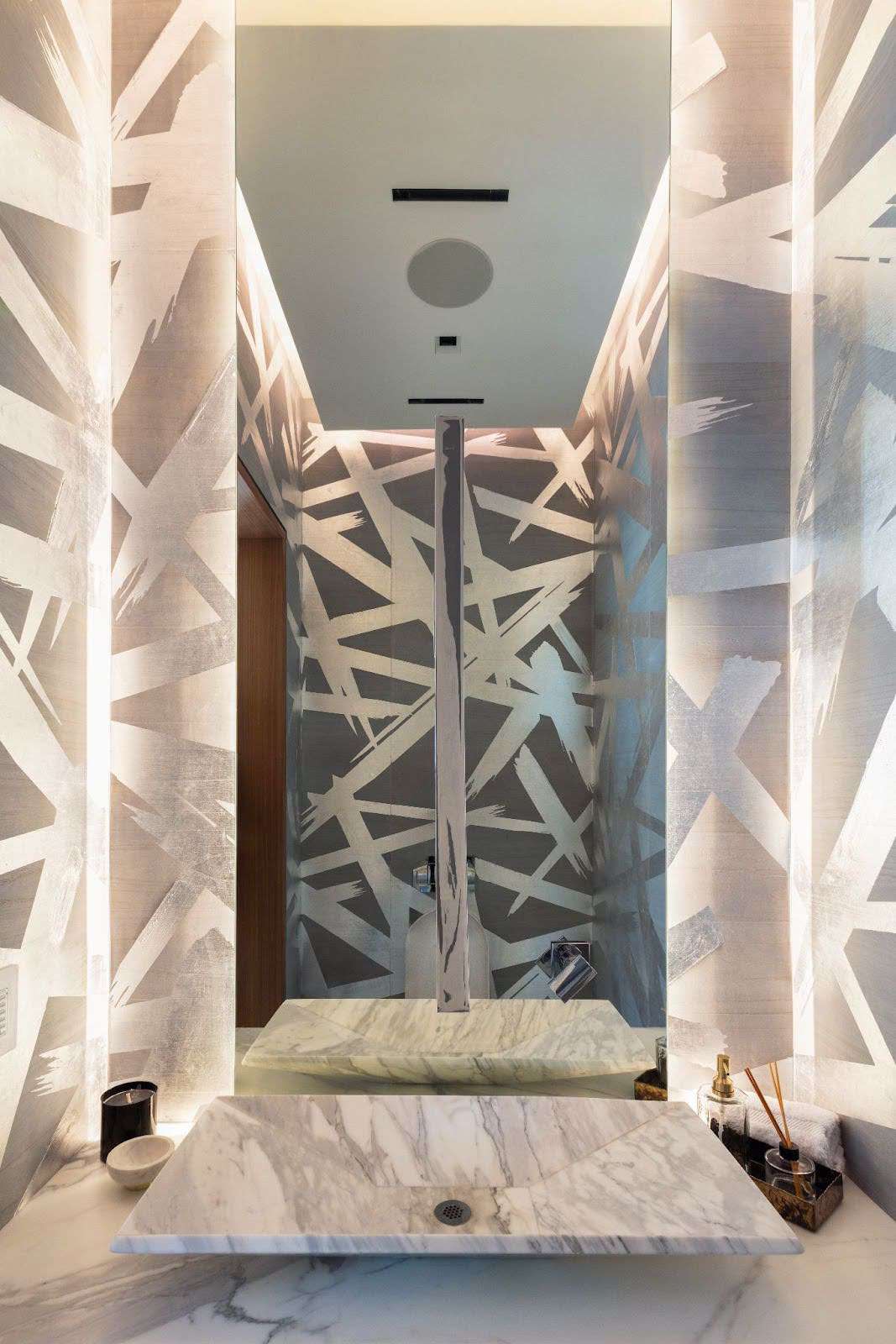 a white bathroom with wallpaper