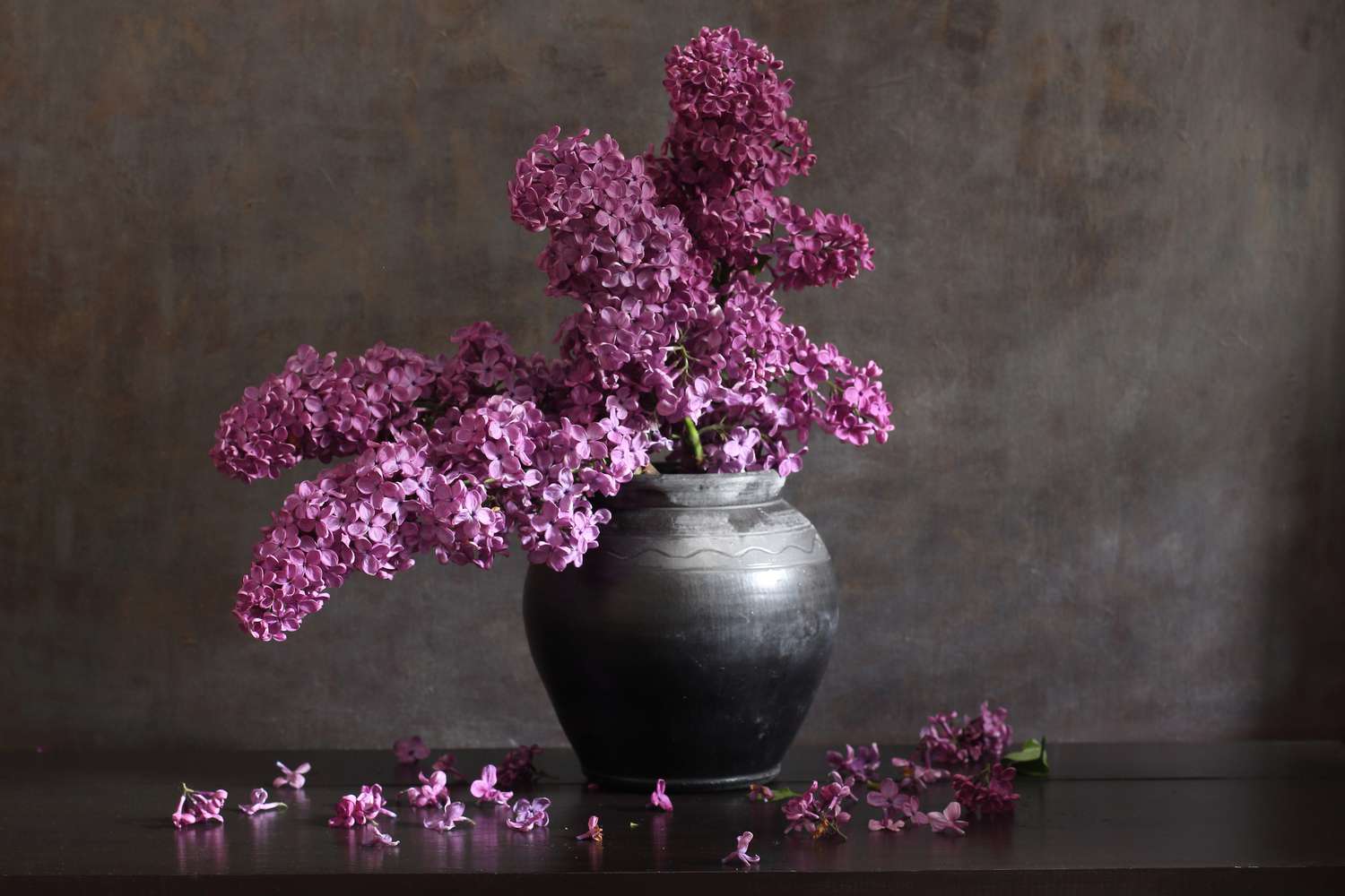 purple lilacs in black vase