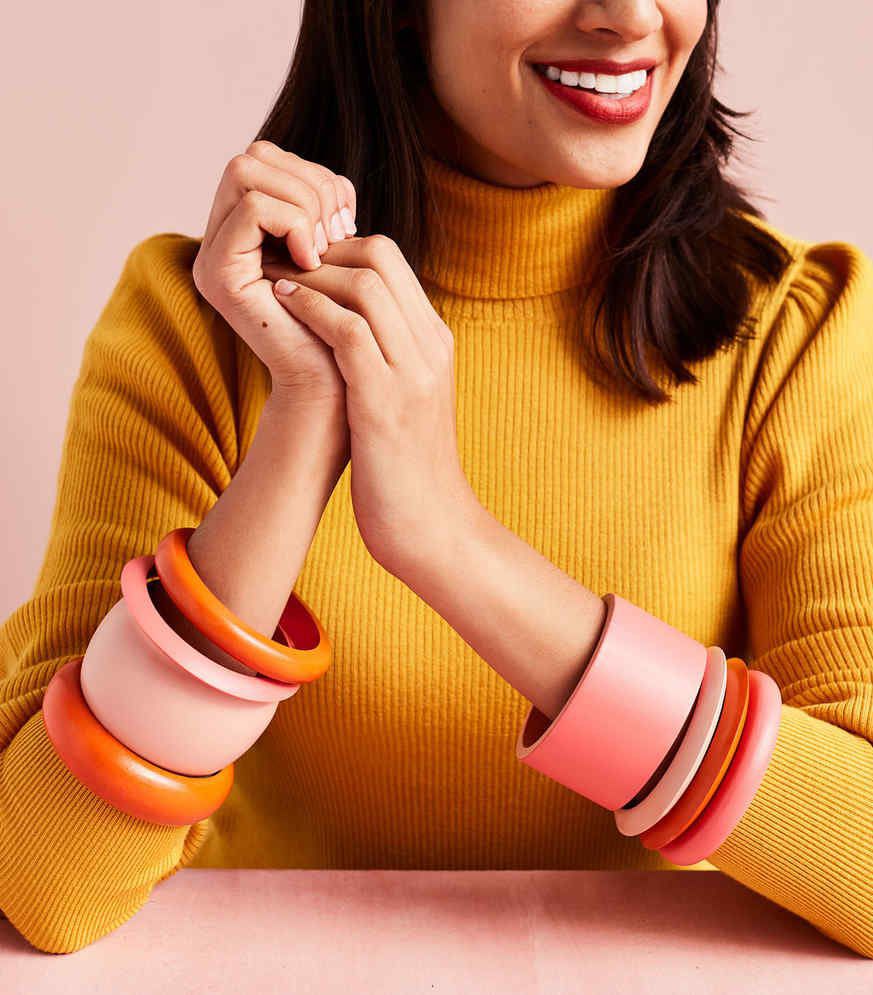 woman wearing painted wooden bangles