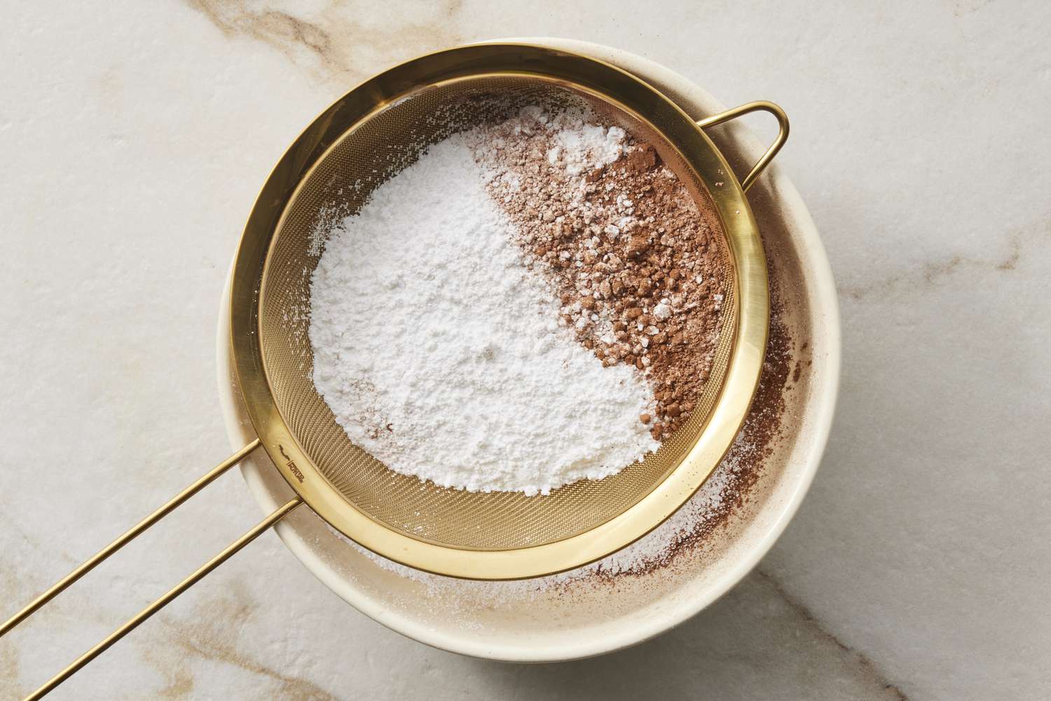 Dry ingredients for chocolate frosting in sifter