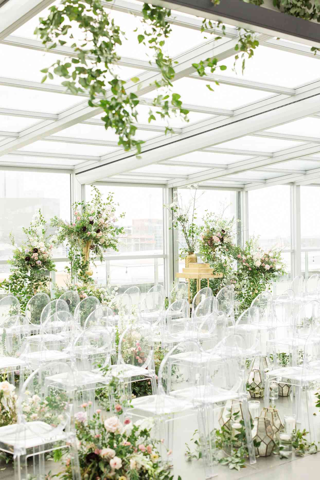 elegant ceremony set up with florals and clear chairs